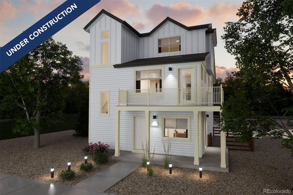 view of front of home with a balcony and board and batten siding