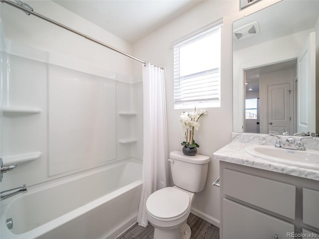 13588 E 103rd Pl, Commerce City, CO 80022 - bathroom featuring baseboards, toilet, shower / bath combo, wood finished floors, and vanity