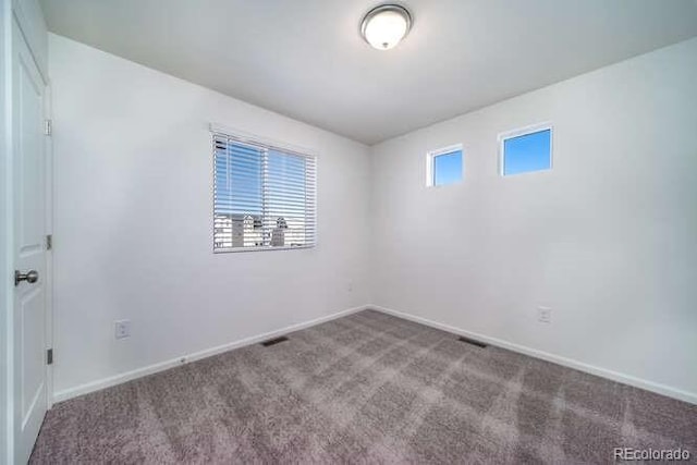 13588 E 103rd Pl, Commerce City, CO 80022 - spare room featuring baseboards and carpet flooring