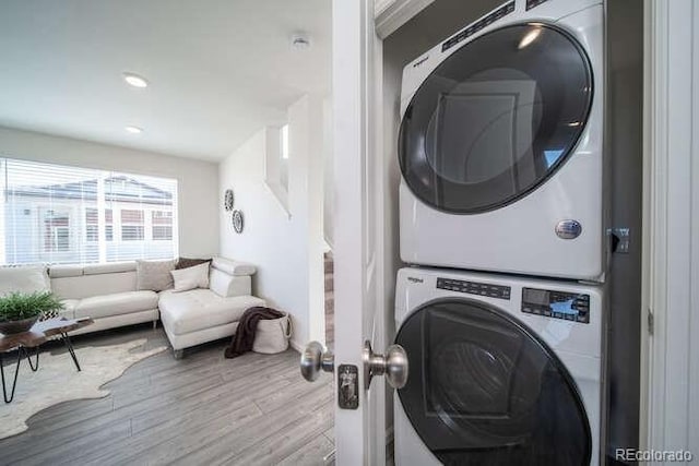 13588 E 103rd Pl, Commerce City, CO 80022 - laundry room with recessed lighting, wood finished floors, laundry area, and stacked washing maching and dryer