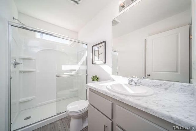 13588 E 103rd Pl, Commerce City, CO 80022 - bathroom with visible vents, vanity, a shower stall, and toilet