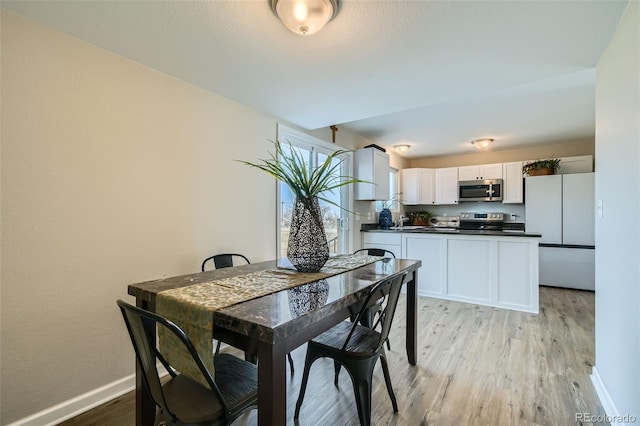 dining space with light hardwood / wood-style flooring