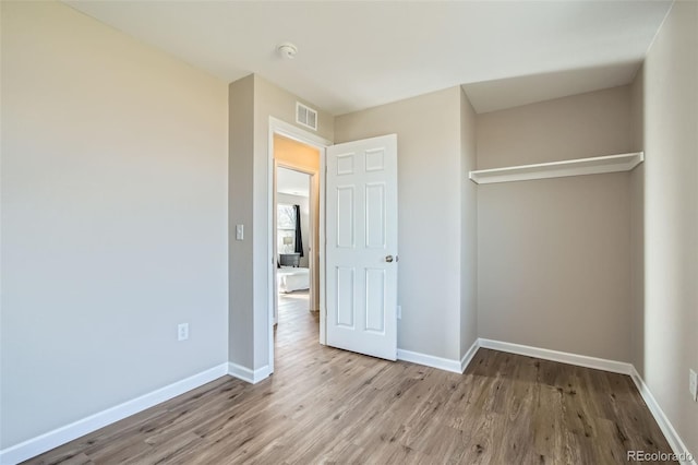 unfurnished bedroom with light wood-type flooring