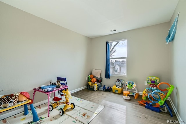 recreation room with light hardwood / wood-style floors