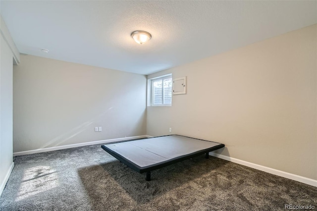 unfurnished bedroom with a textured ceiling and carpet