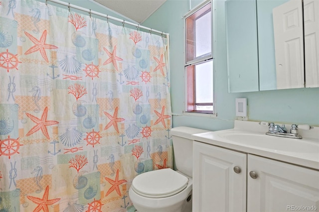 bathroom featuring toilet, a shower with shower curtain, vaulted ceiling, and vanity