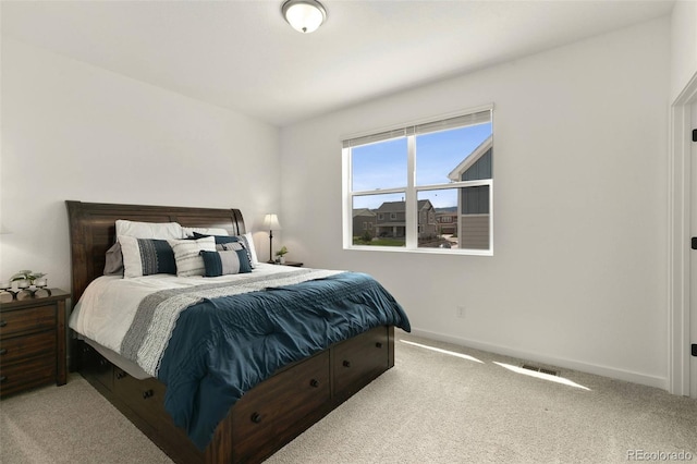 carpeted bedroom featuring visible vents and baseboards