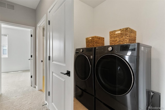 laundry room with visible vents, light carpet, laundry area, and washer and clothes dryer