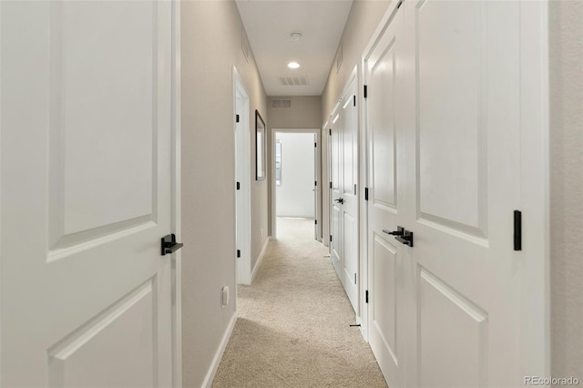 corridor with recessed lighting, visible vents, light colored carpet, and baseboards