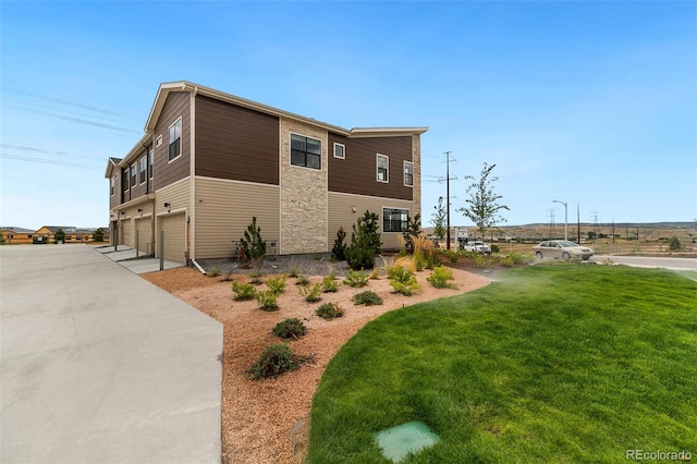 view of property exterior featuring driveway, a lawn, and an attached garage