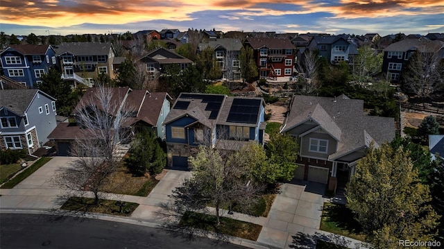aerial view at dusk featuring a residential view