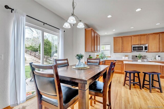 dining space with recessed lighting and light wood finished floors