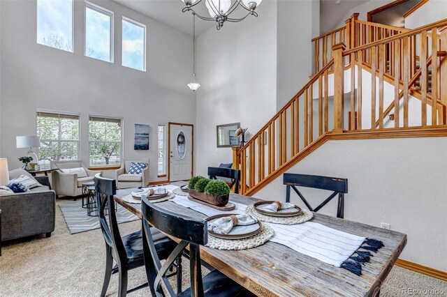 dining area with carpet, a chandelier, plenty of natural light, and stairway