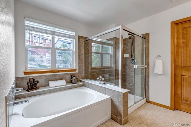 bathroom featuring a garden tub and a stall shower