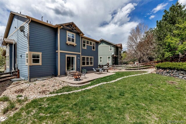 back of house with a lawn and a patio area