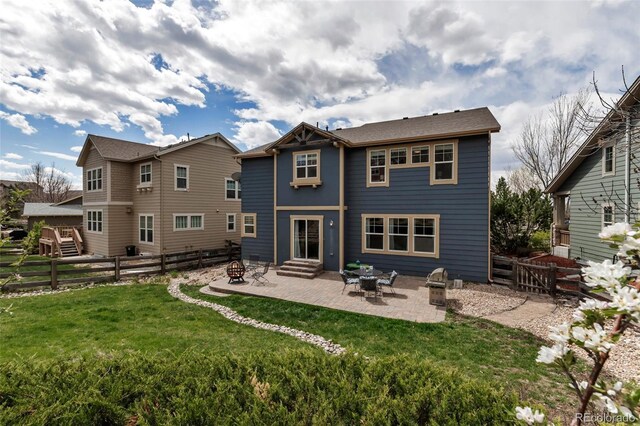 rear view of property with a fenced backyard, a yard, and a patio area