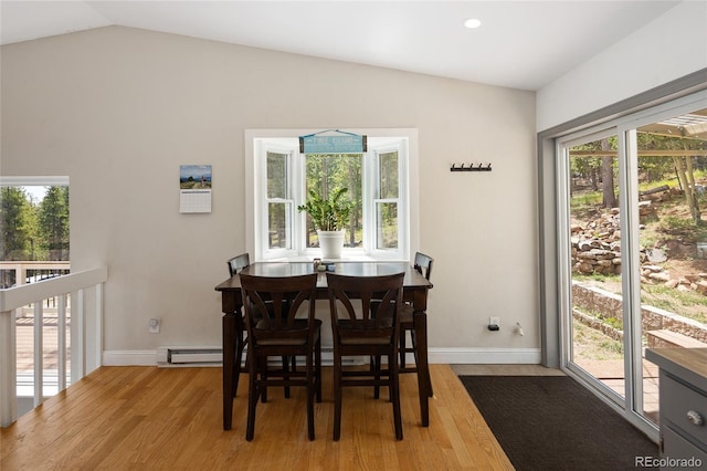 9123 Gray Ln, Conifer, CO 80433 - dining space featuring wood finished floors, a baseboard radiator, and vaulted ceiling