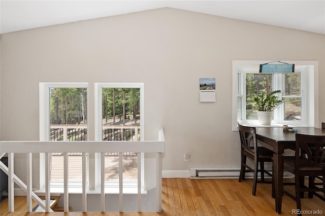 9123 Gray Ln, Conifer, CO 80433 - dining area with vaulted ceiling, plenty of natural light, and wood finished floors