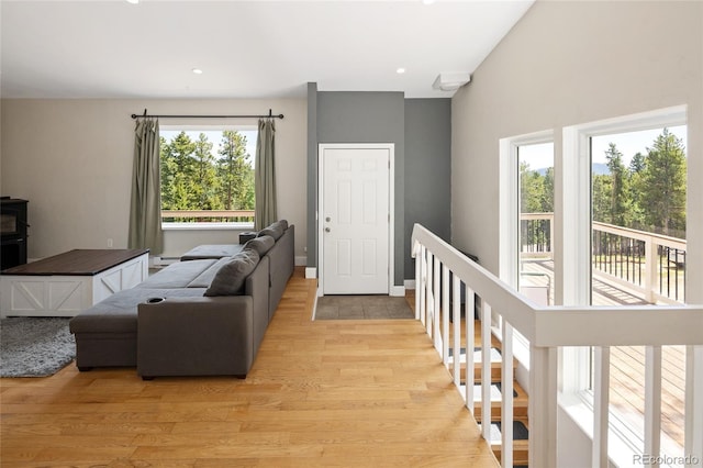 9123 Gray Ln, Conifer, CO 80433 - living room featuring light wood finished floors, a wood stove, and recessed lighting
