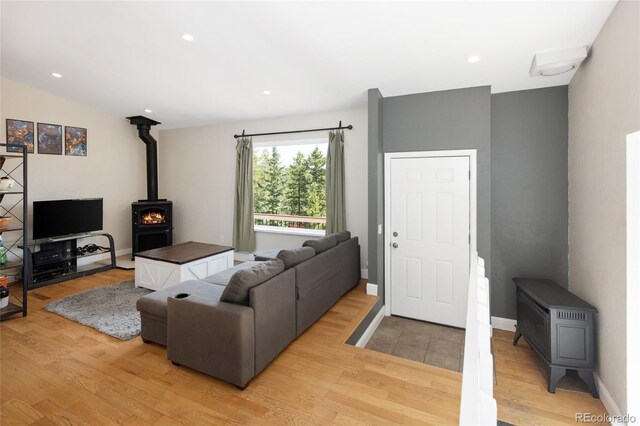 9123 Gray Ln, Conifer, CO 80433 - living area featuring a wood stove, light wood finished floors, and recessed lighting
