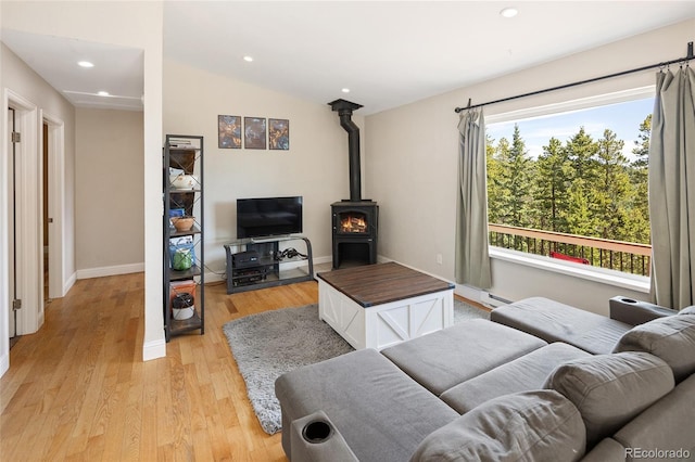 9123 Gray Ln, Conifer, CO 80433 - living room with recessed lighting, baseboard heating, light wood-type flooring, a wood stove, and lofted ceiling