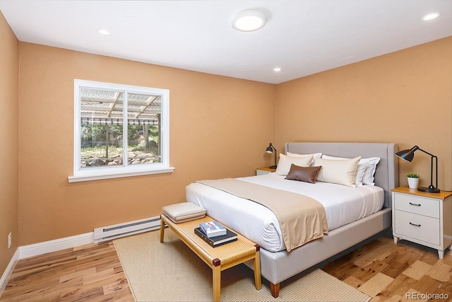 9123 Gray Ln, Conifer, CO 80433 - bedroom with baseboard heating, light wood-style floors, and recessed lighting