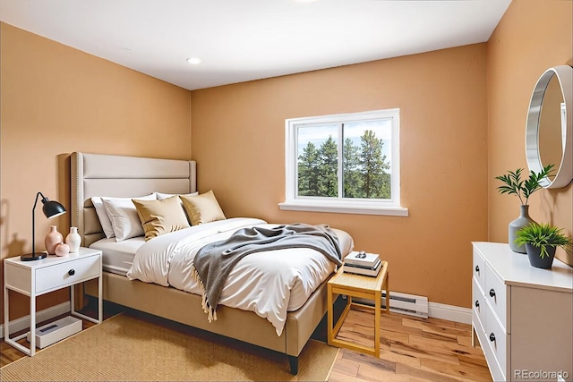 9123 Gray Ln, Conifer, CO 80433 - bedroom featuring light wood-type flooring and a baseboard radiator