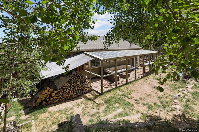 9123 Gray Ln, Conifer, CO 80433 - view of side of property with a patio and a shingled roof