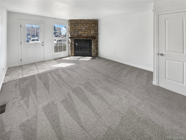 unfurnished living room featuring a fireplace, baseboards, and carpet floors