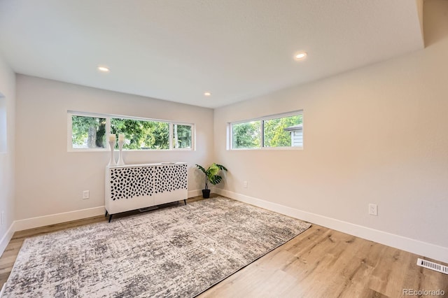 1640 Iola St, Aurora, CO 80010 - unfurnished room with wood finished floors, recessed lighting, and radiator heating unit