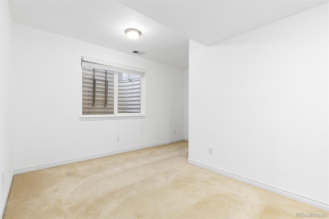 carpeted empty room with visible vents and baseboards