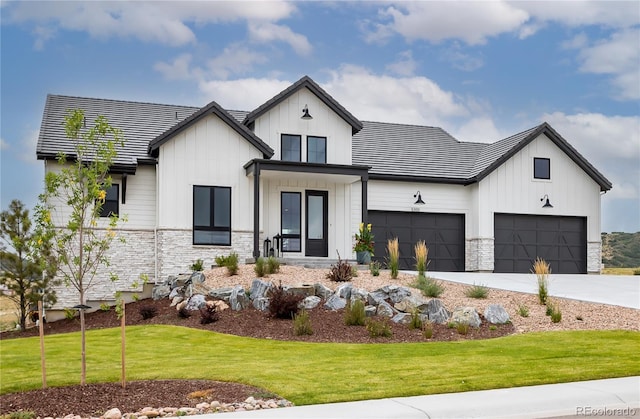 modern farmhouse featuring a garage and a front lawn