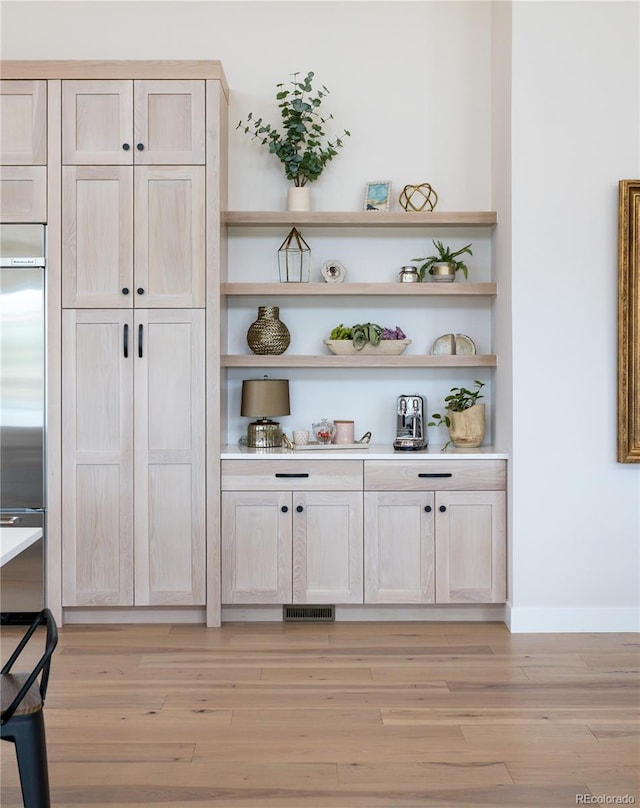 interior space featuring light hardwood / wood-style flooring and light brown cabinetry