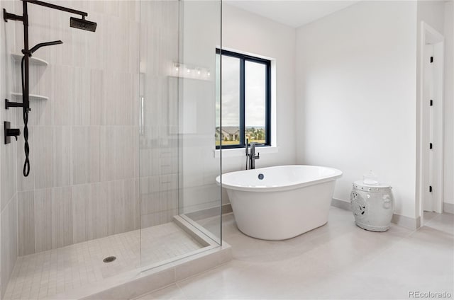 bathroom with independent shower and bath and tile patterned floors