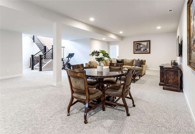 carpeted dining space with plenty of natural light