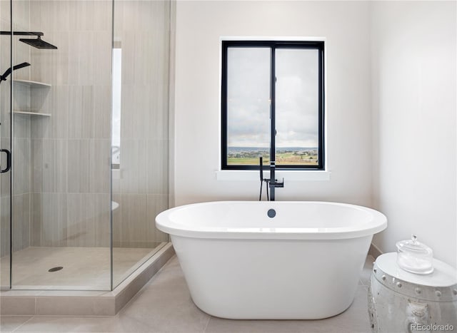 bathroom with an enclosed shower and tile patterned floors