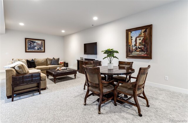 dining area with light colored carpet