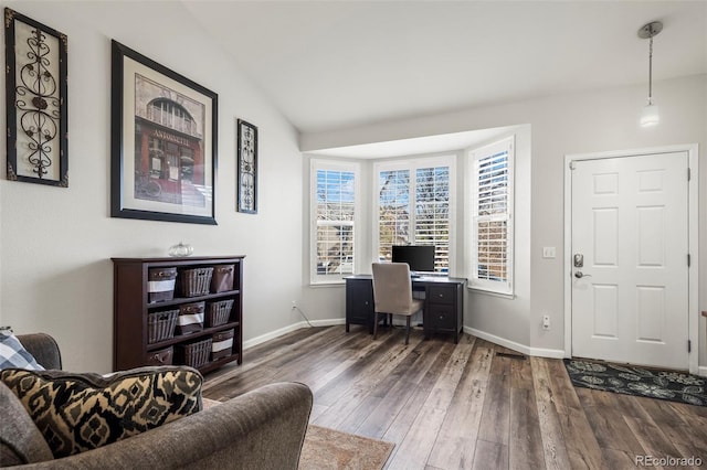 home office with dark hardwood / wood-style flooring and vaulted ceiling