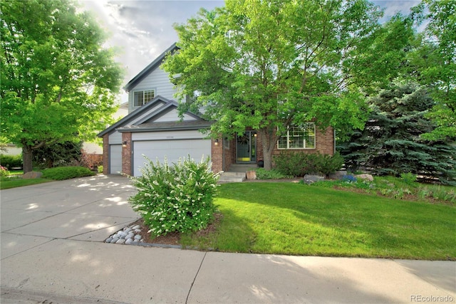 10356 Lions Heart, Lone Tree, CO 80124 - obstructed view of property featuring brick siding, driveway, a front lawn, and an attached garage