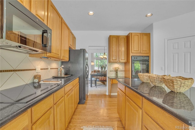 10356 Lions Heart, Lone Tree, CO 80124 - kitchen with black appliances, tasteful backsplash, light wood finished floors, dark stone countertops, and recessed lighting