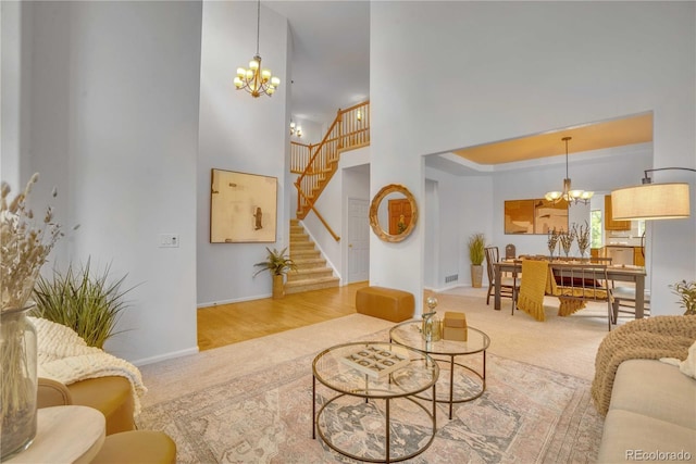 10356 Lions Heart, Lone Tree, CO 80124 - carpeted living area featuring a chandelier, stairs, and a towering ceiling