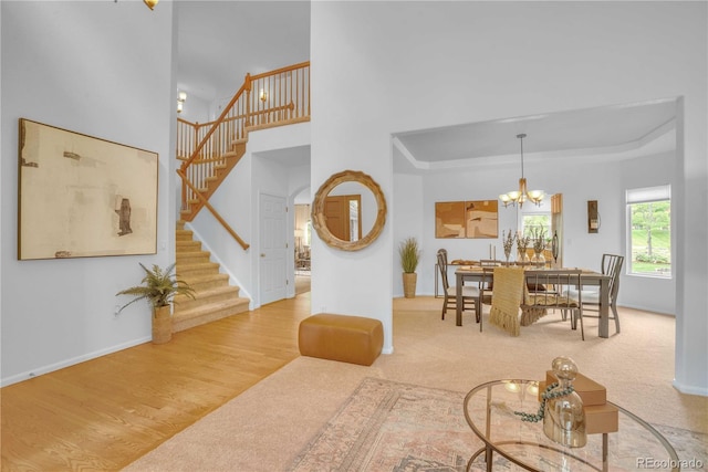 10356 Lions Heart, Lone Tree, CO 80124 - carpeted living room with stairs, a chandelier, and a raised ceiling