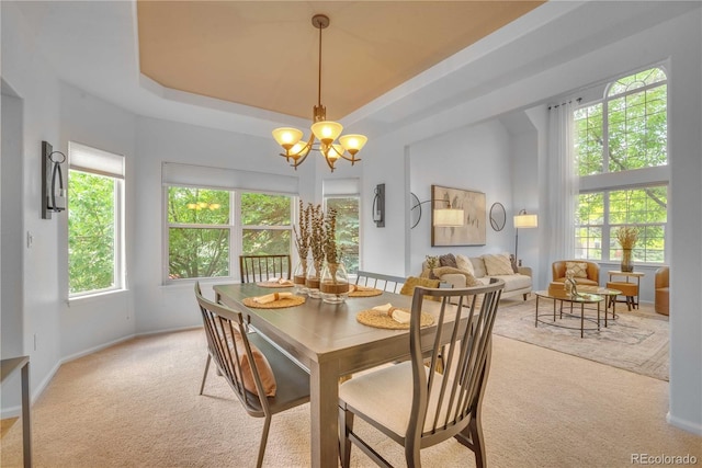 10356 Lions Heart, Lone Tree, CO 80124 - dining room with light colored carpet, a chandelier, and a raised ceiling