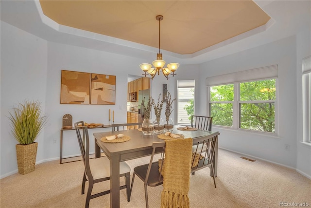 10356 Lions Heart, Lone Tree, CO 80124 - dining space with a raised ceiling, light carpet, and a chandelier
