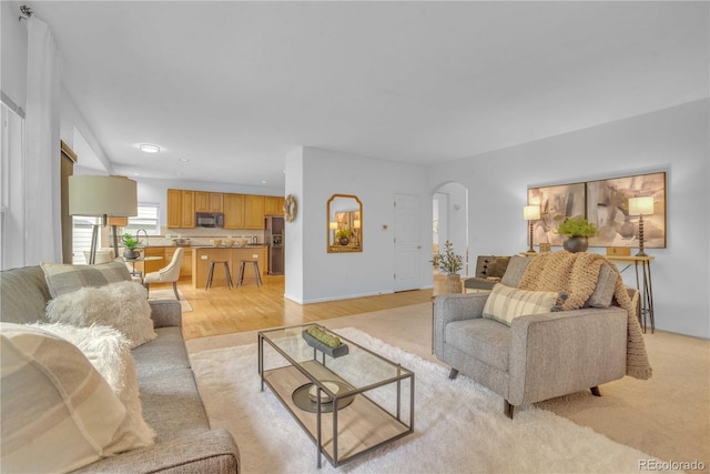 10356 Lions Heart, Lone Tree, CO 80124 - living area with arched walkways, light wood-style flooring, and recessed lighting