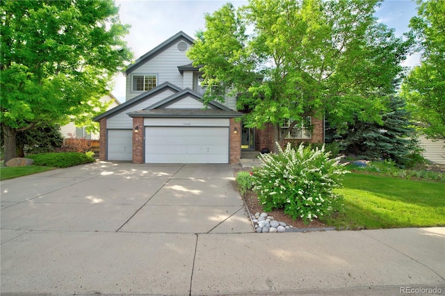 10356 Lions Heart, Lone Tree, CO 80124 - view of front of property with concrete driveway, brick siding, an attached garage, and a front lawn
