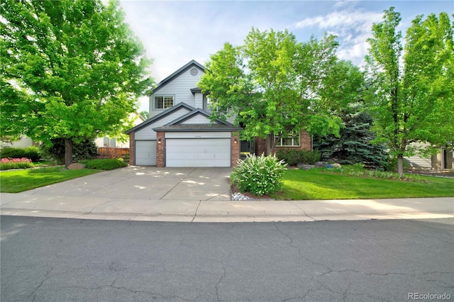 10356 Lions Heart, Lone Tree, CO 80124 - view of front facade with concrete driveway, a front lawn, a garage, and brick siding