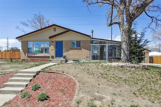 10505 Clarkson St, Northglenn, CO 80233 - view of front of property featuring brick siding and a sunroom