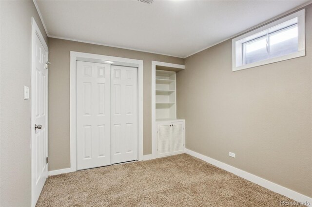 10505 Clarkson St, Northglenn, CO 80233 - unfurnished bedroom featuring carpet, ornamental molding, a closet, and baseboards