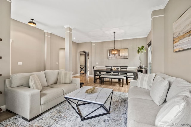 10553 Stonemeadow Dr, Parker, CO 80134 - living area featuring arched walkways, wood finished floors, decorative columns, and recessed lighting